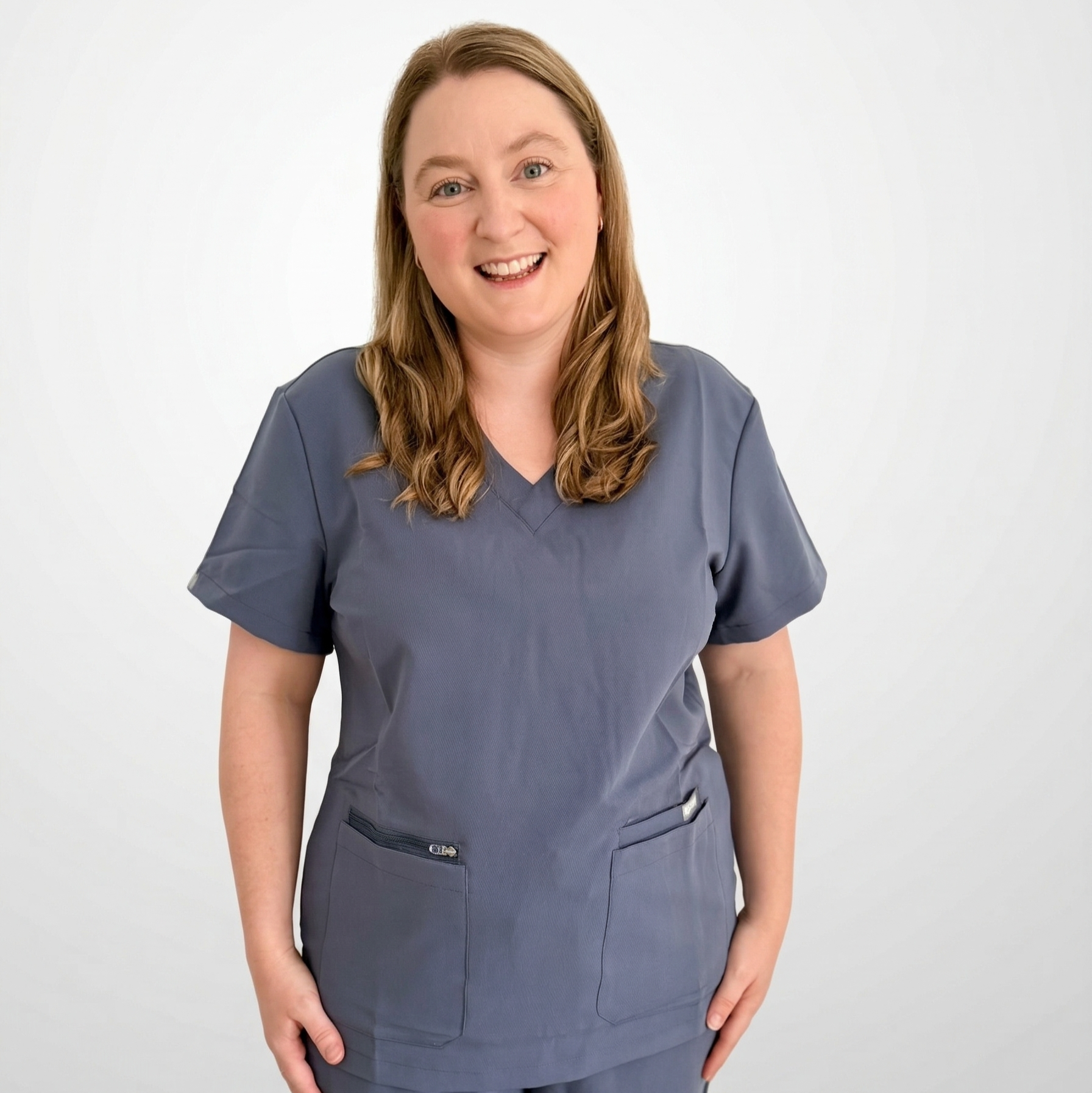 Person wearing a gray scrub set on a white background